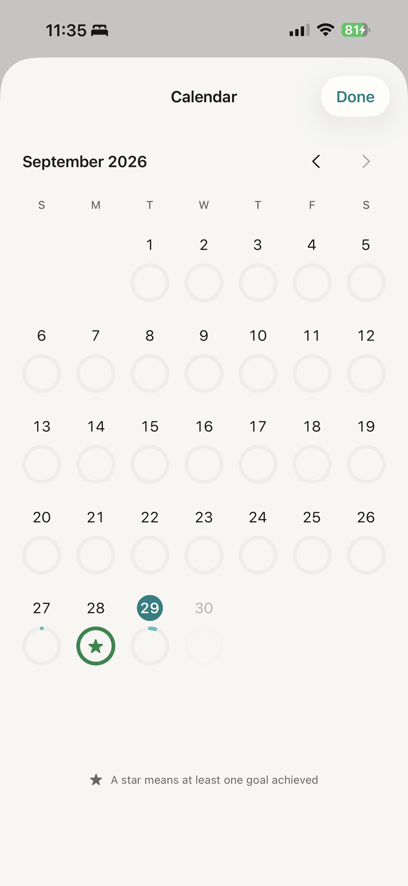 September calendar with daily progress rings and a star marking a completed goal
